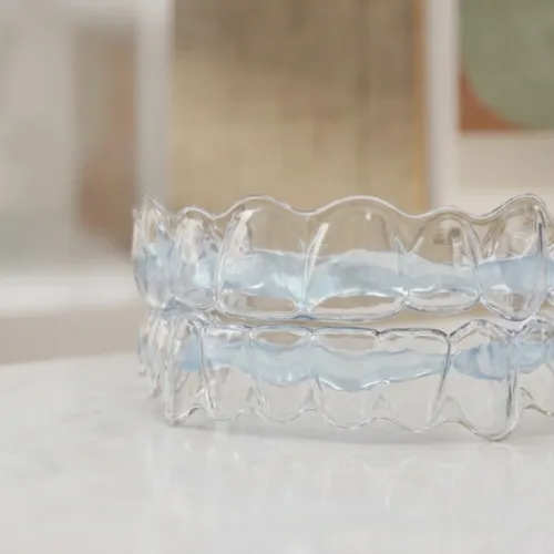 Clear aligners with whitening gel on surface.