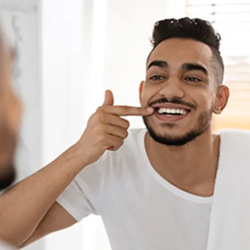 man-smiling-into-mirror