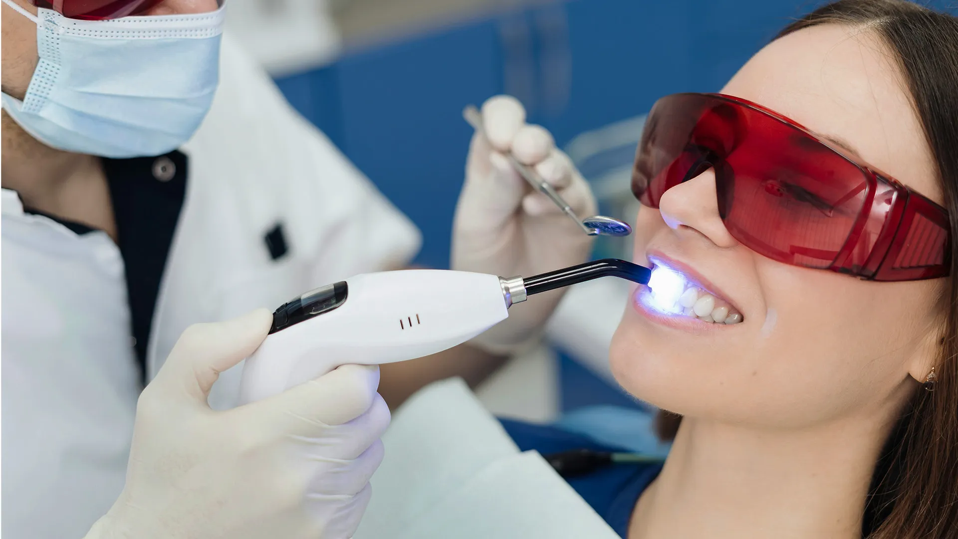 Teeth whitening procedure with blue curing light