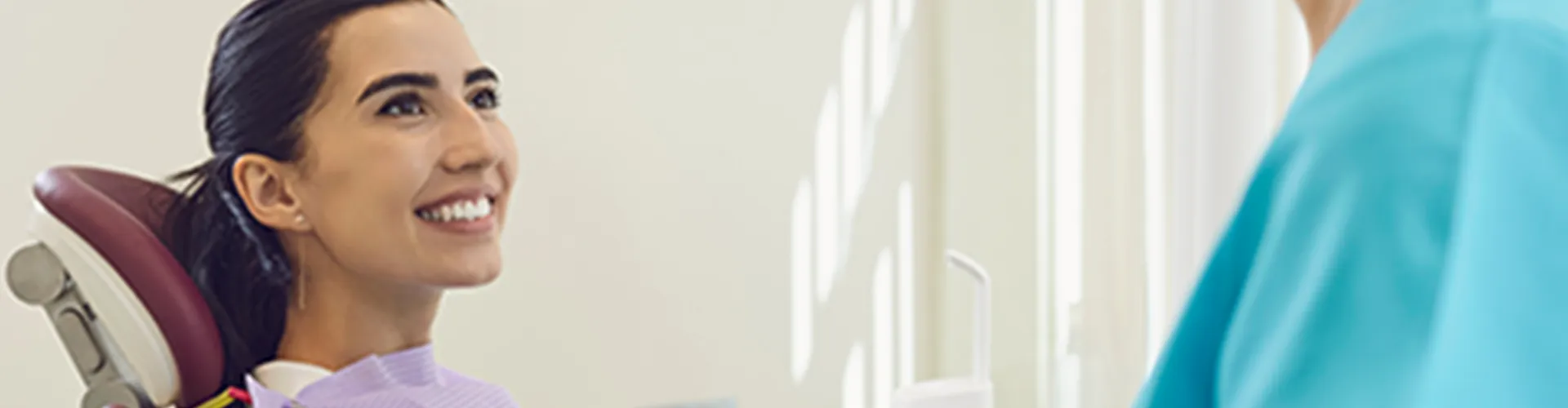 A woman smiling at the dentist.