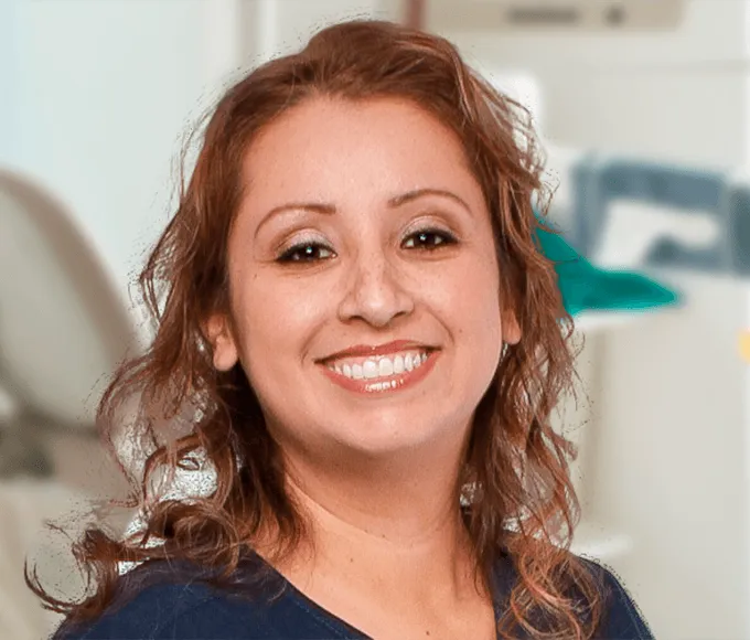Friendly female dental hygienist smiling