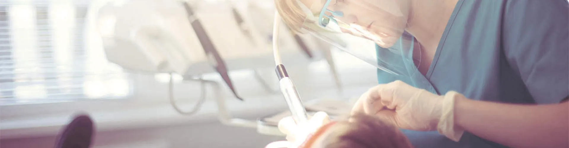 Dentist performing a dental cleaning.