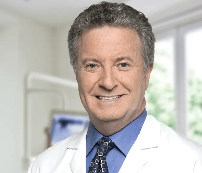 Smiling male dentist in a white coat