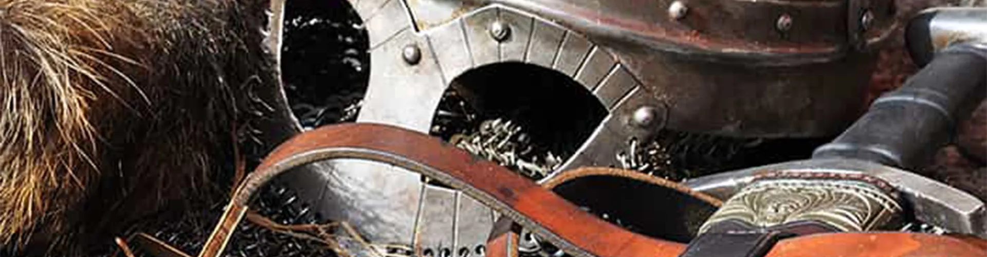 An old metal combat helmet next to a sword.