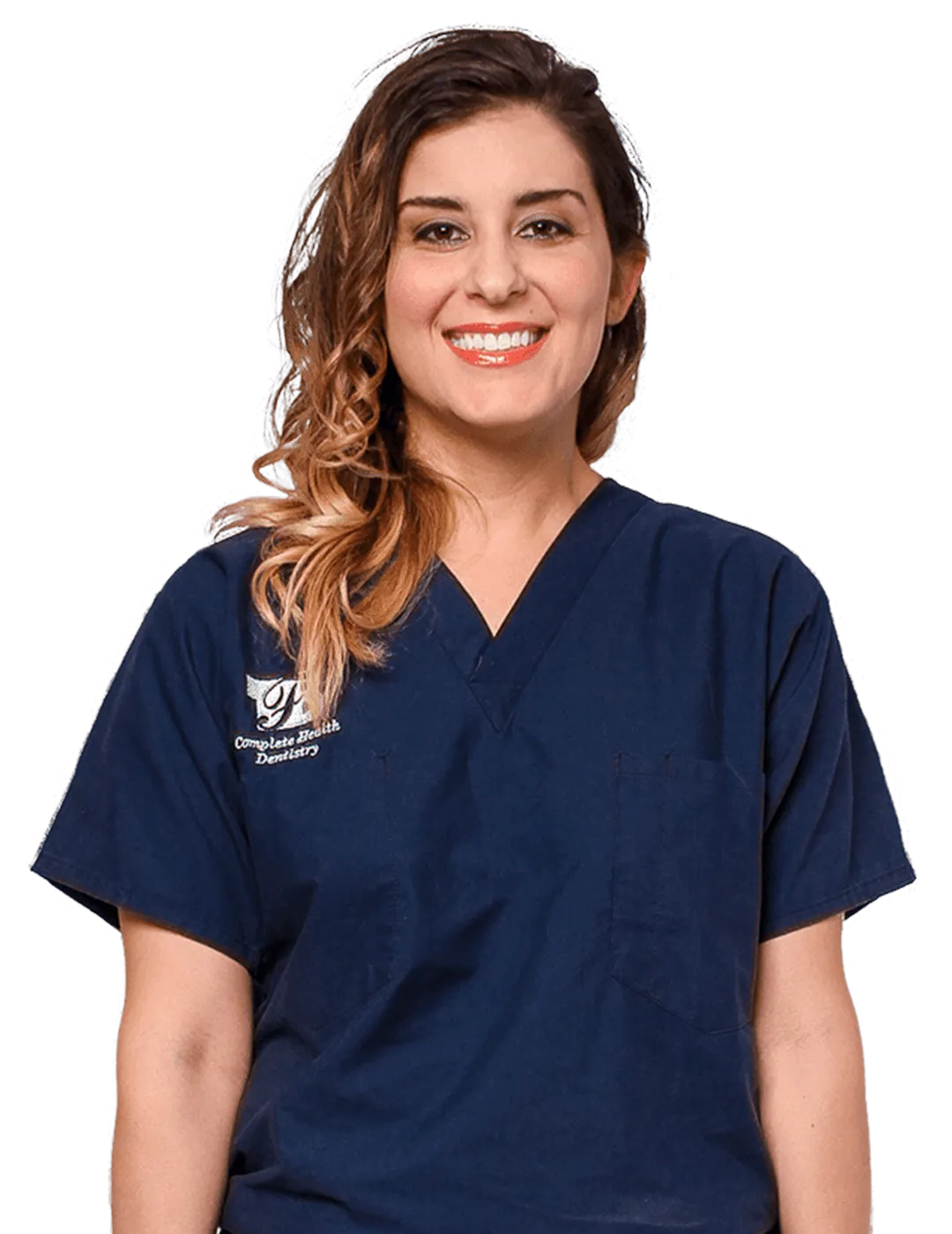 Smiling female dental hygienist in navy blue Complete Health Dentistry scrubs.