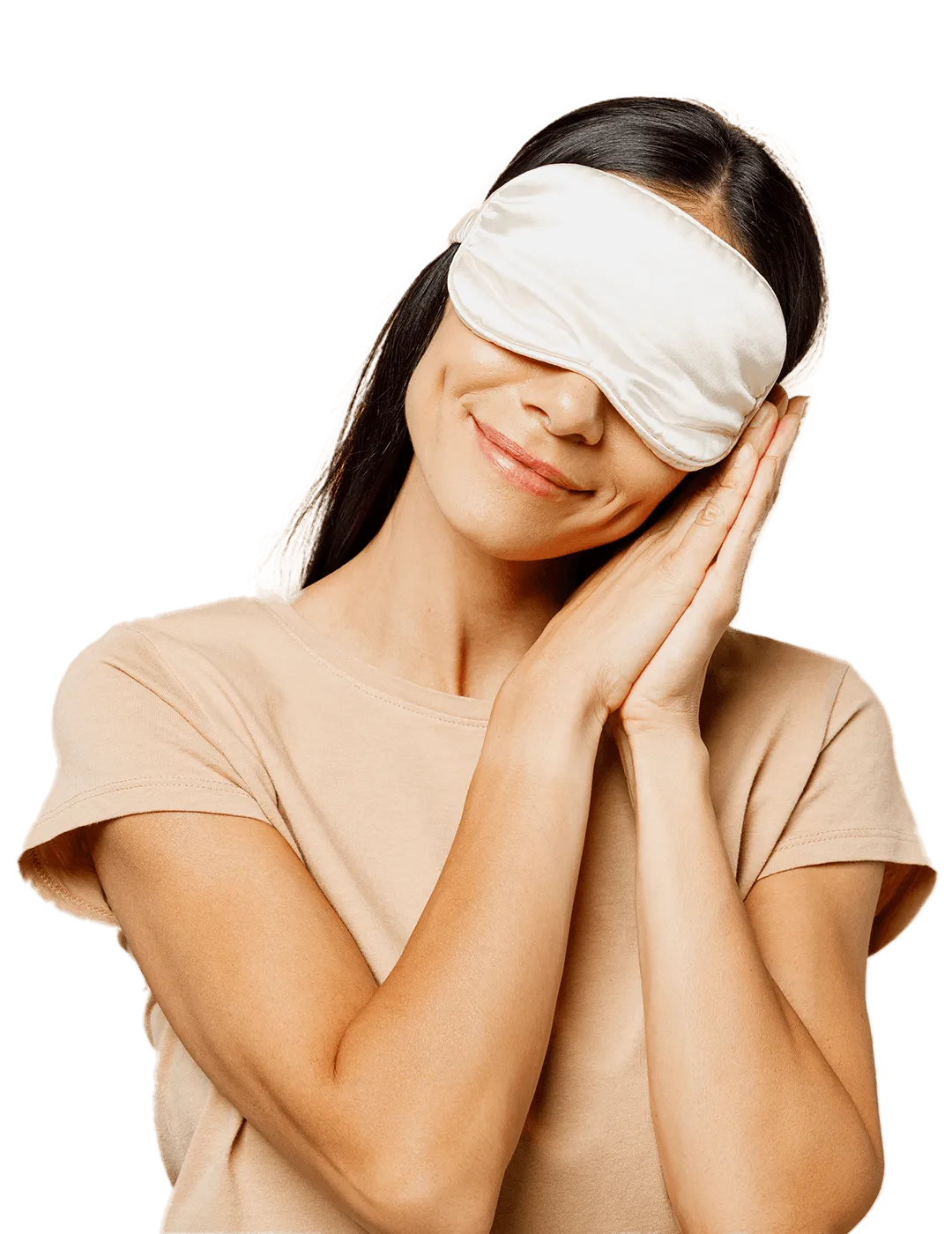 Smiling woman wearing a silk sleep mask, hands clasped under her chin.