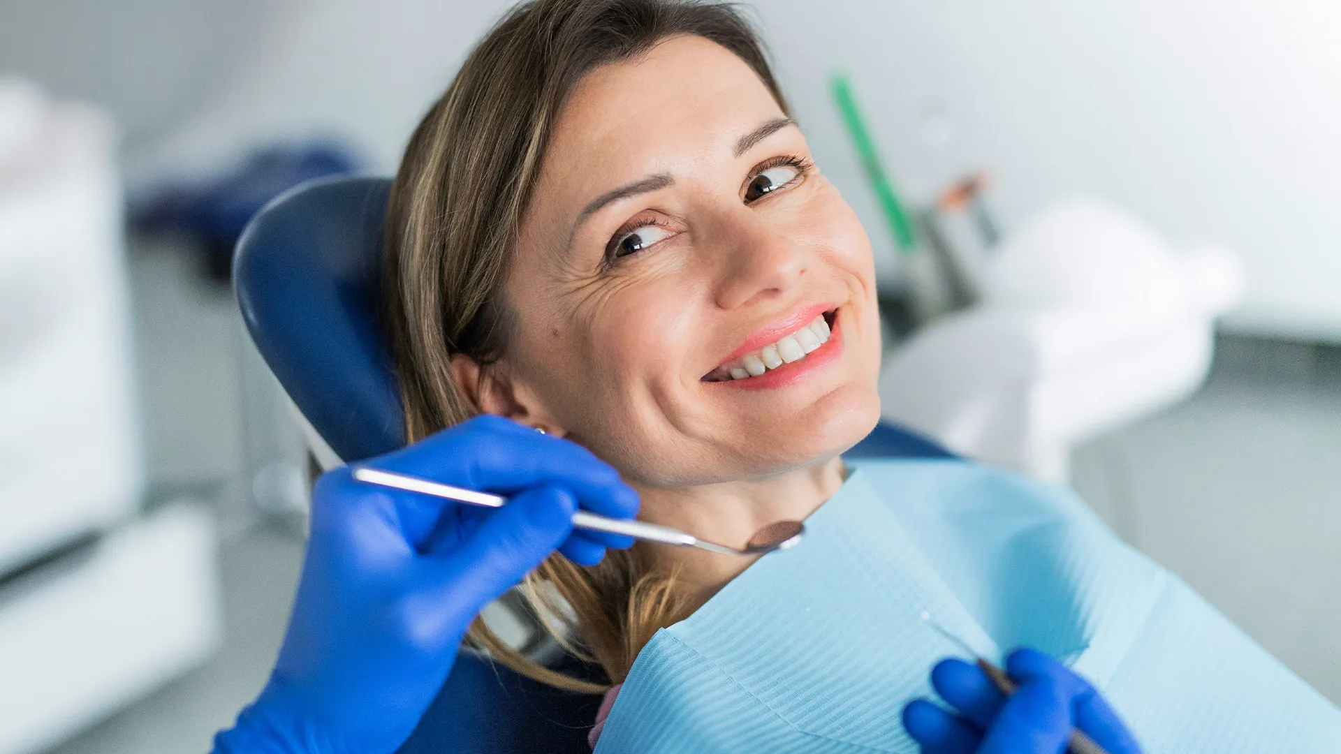 Smiling woman during dental checkup appointment.