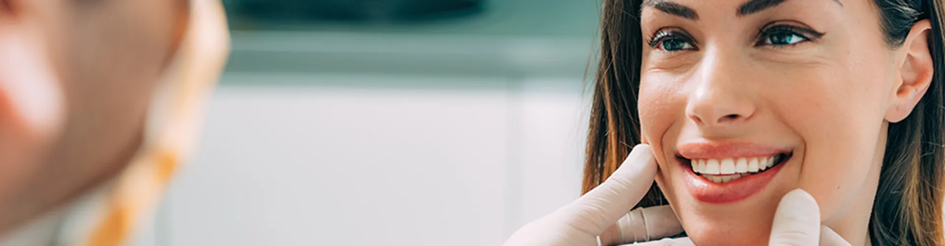 A dentist checking a patient smile.