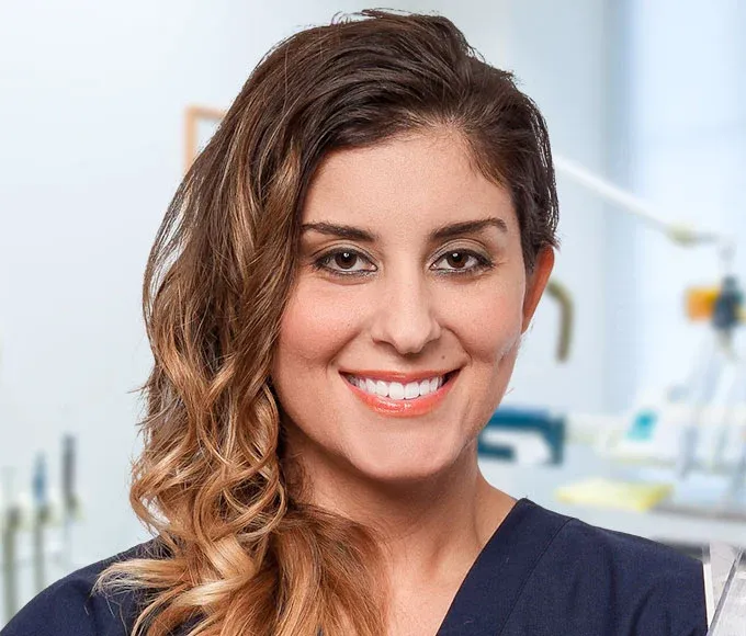 Friendly female dentist smiling in dental office